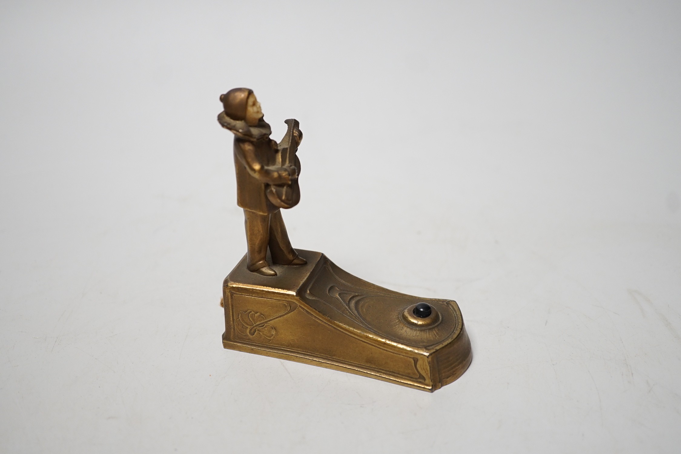 An Art Deco violin player bell with ivory face inset 9.5cm